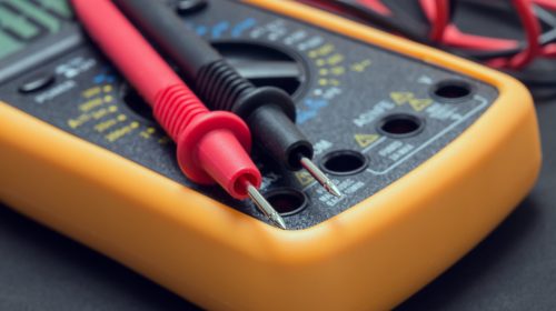 multimeter and tester on black background