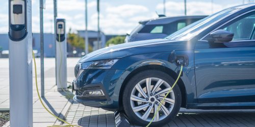 Electric car charging at a station in Europe